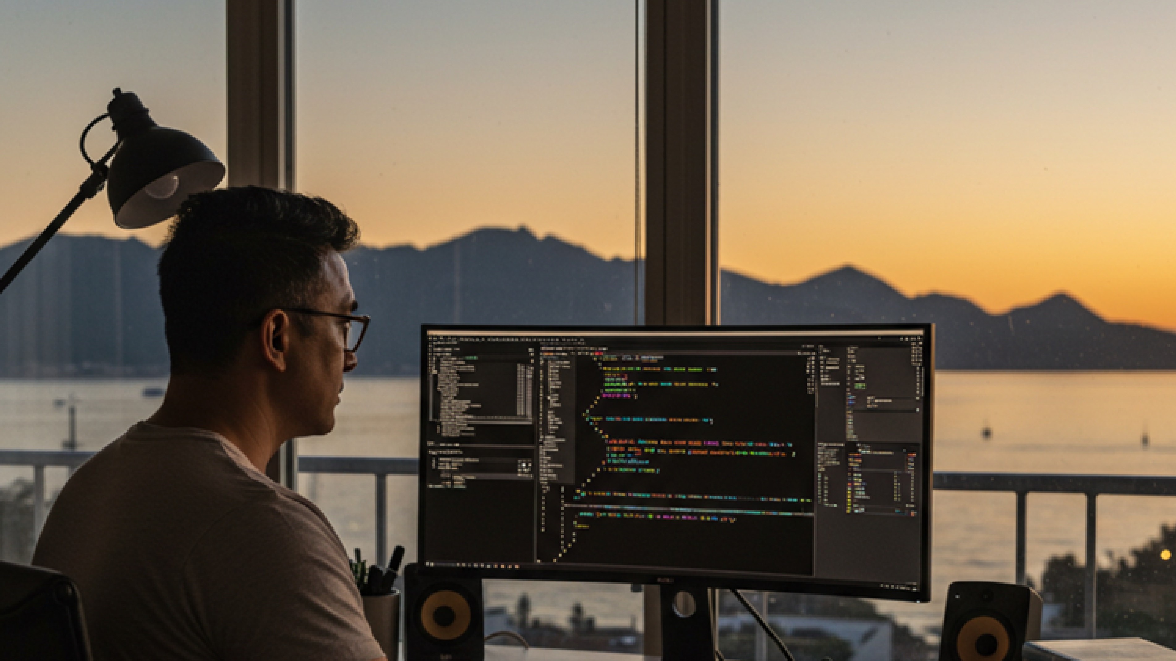 Kashif's workspace with sunset view